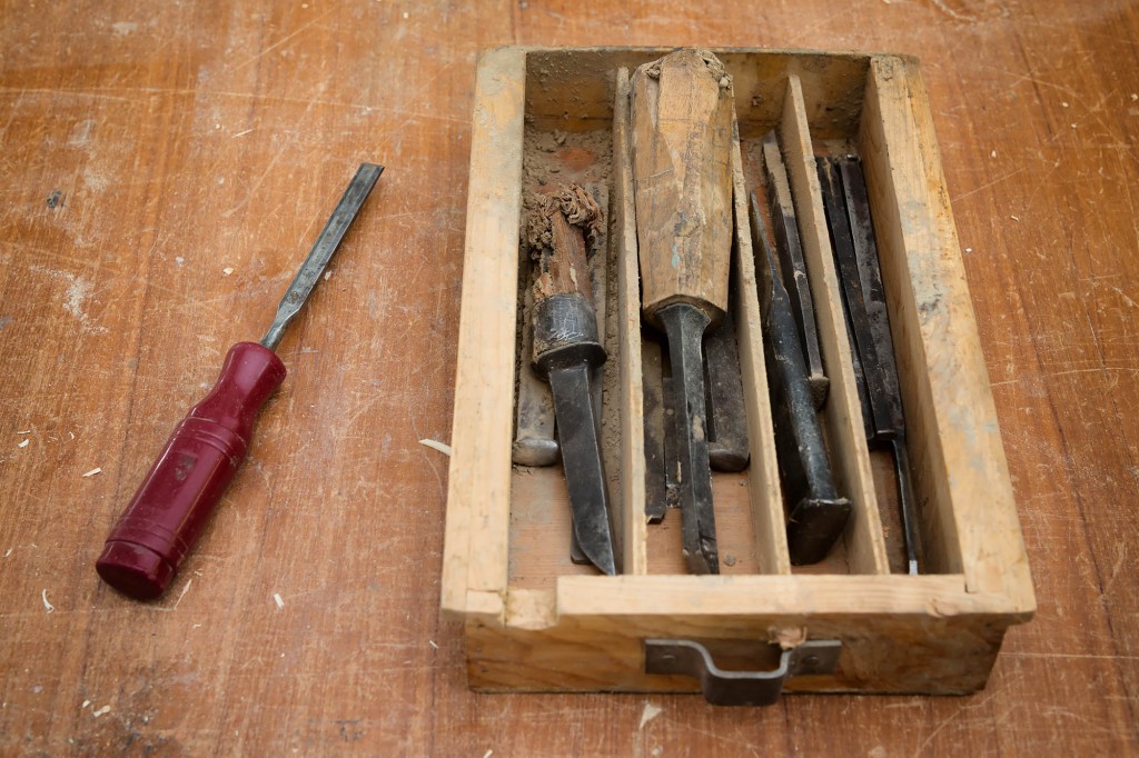 Carpenter or woodworker tools: old chisels in wood box